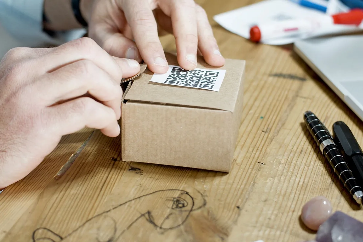 Digital Marketing Agency | ZenWeb Malaysia Hands packing an online order into a cardboard box