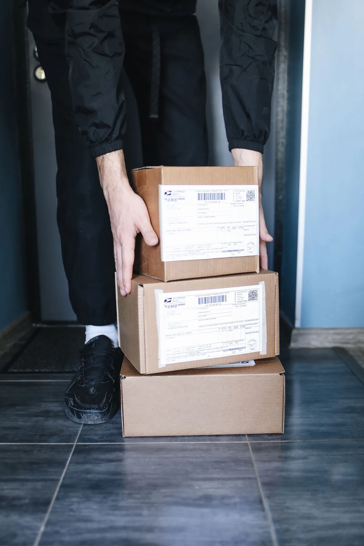 Digital Marketing Agency | ZenWeb Malaysia A store owner checking stacked cardboard boxes of stock