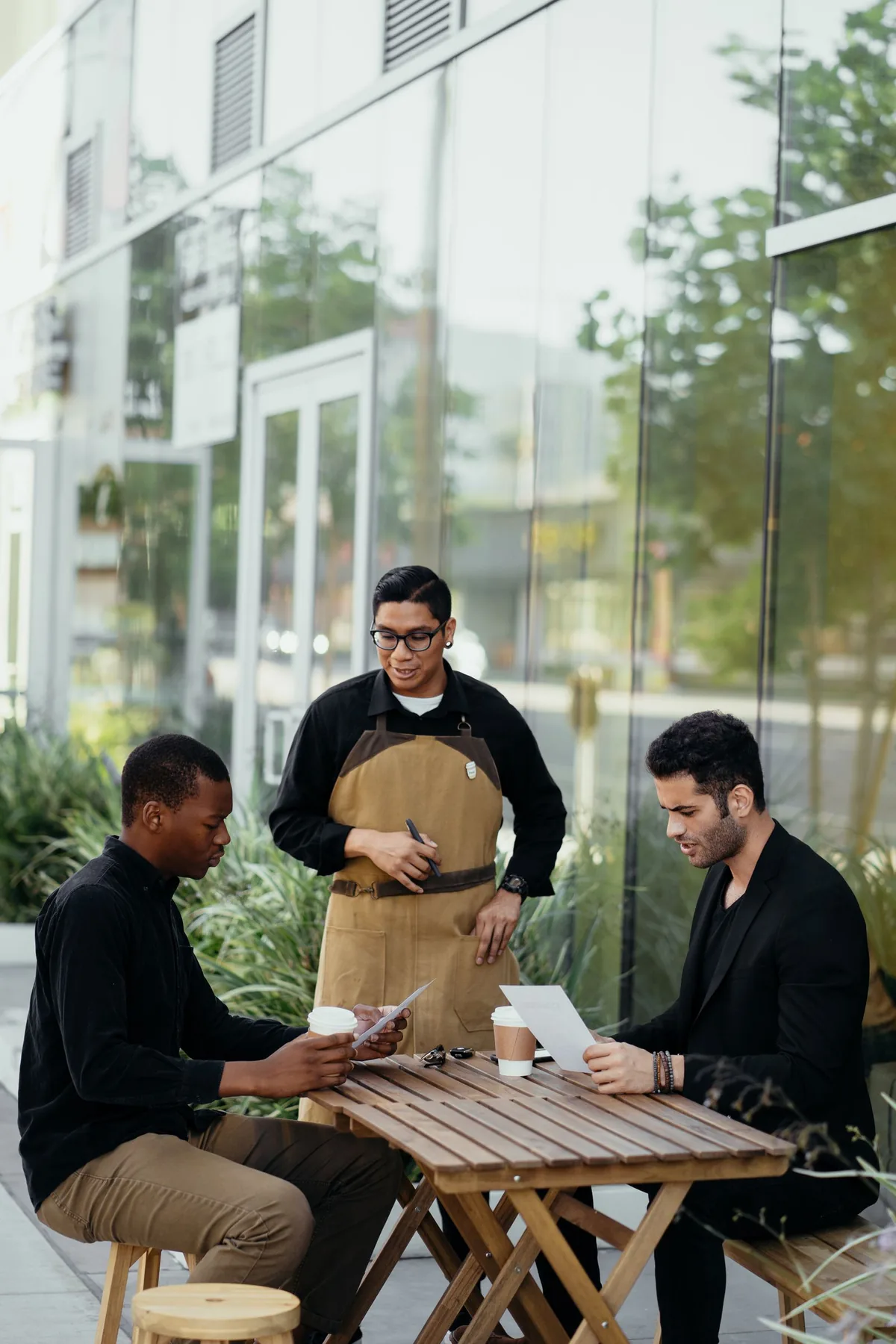 Digital Marketing Agency | ZenWeb Malaysia A waiter taking an order from customers at a restaurant table