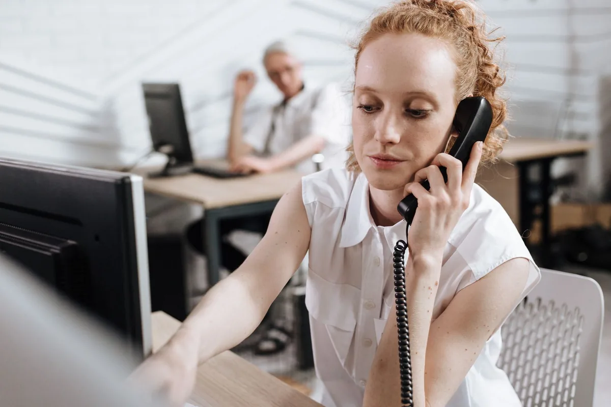 Digital Marketing Agency | ZenWeb Malaysia A woman making a reference call by telephone at her desk